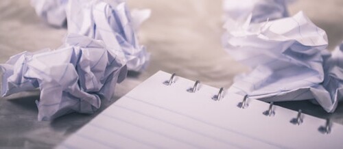 Notebook paper with different essay drafts