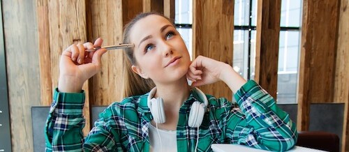 Student thinking about job vs. internship