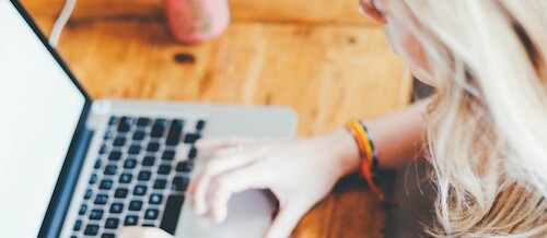 Student writing LOCI on laptop