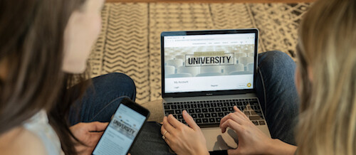 students checking college waitlists on laptop