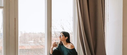 student writing essay looking out window